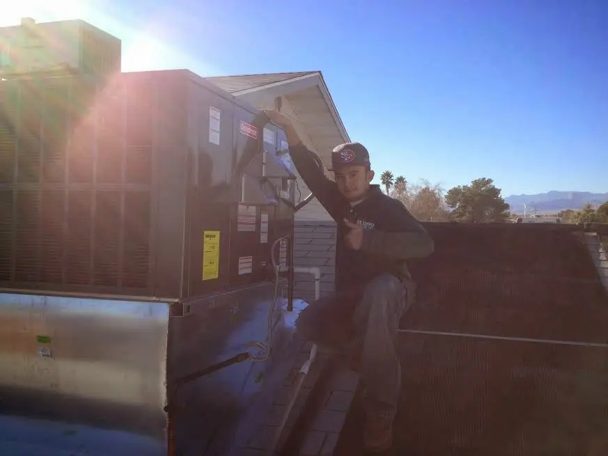 HVAC technician performing HVAC Inspection on a rooftop unit in Kennedale